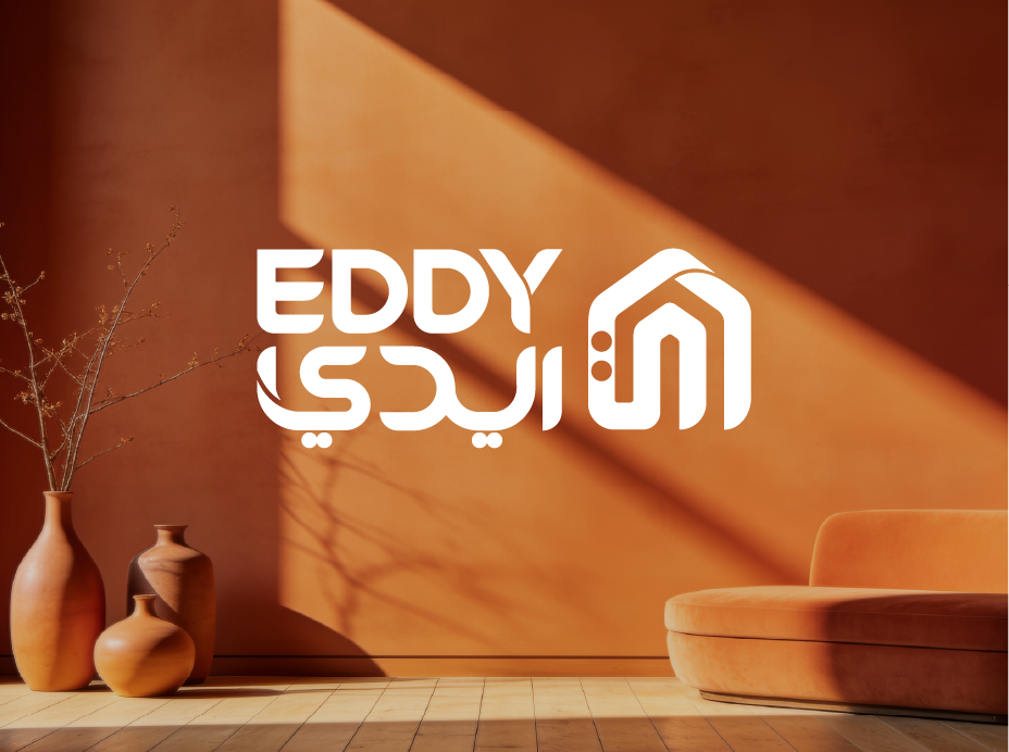 EDDY bilingual Arabic and English logo in copper and charcoal beside a premium pendant lamp